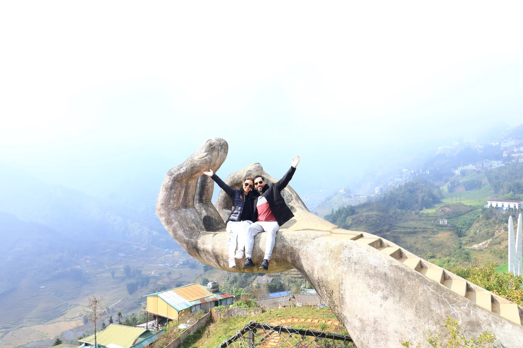 Alastair and Candice sitting together on the Bàn Tay Vàng viewpoint above Sa Pa