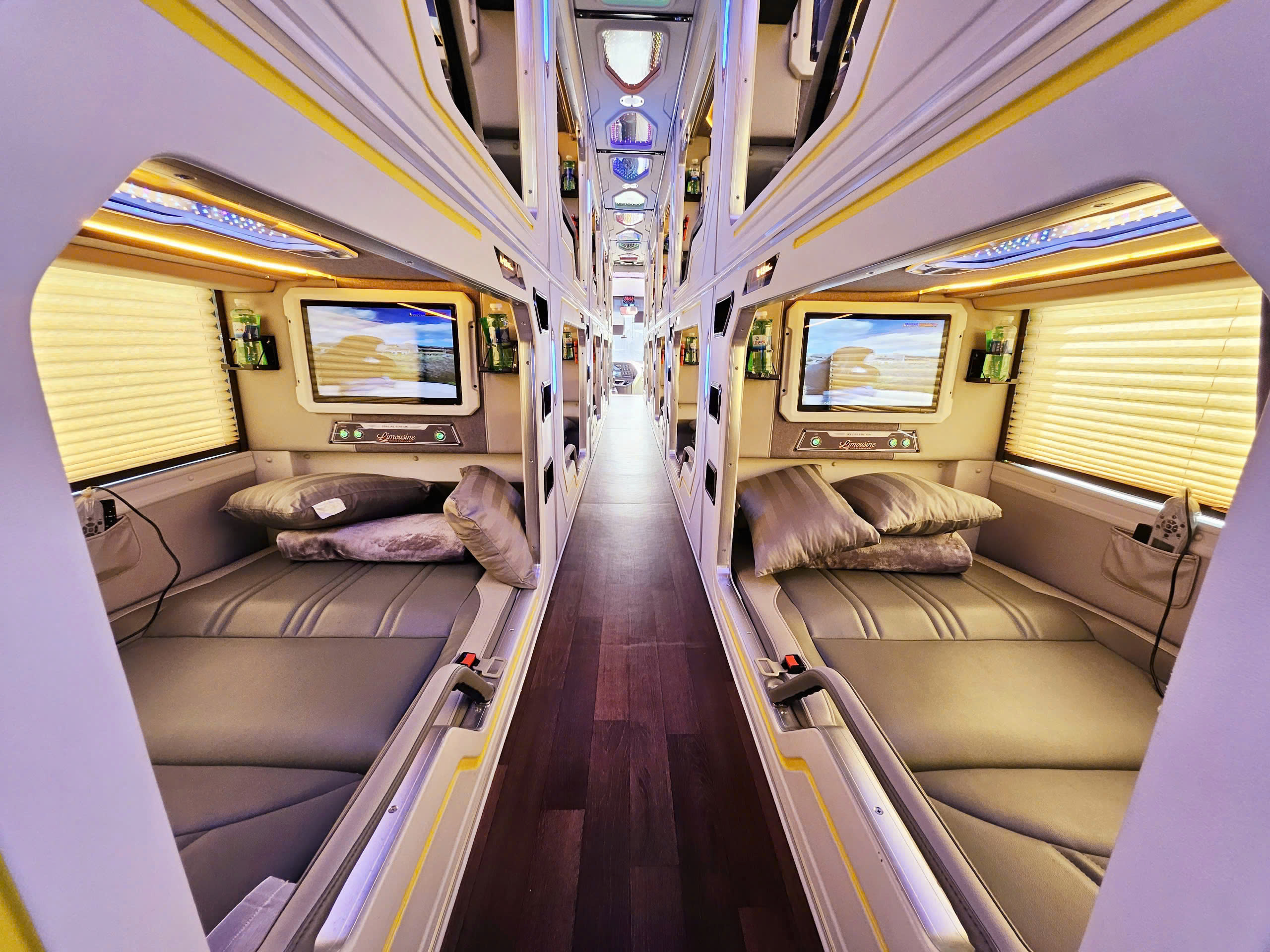 Private sleeper cabins and a central aisle aboard an HK Buslines coach